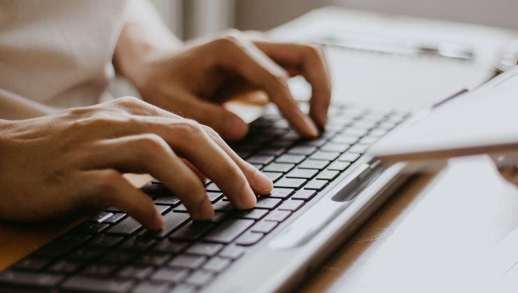 person typing on keyboard